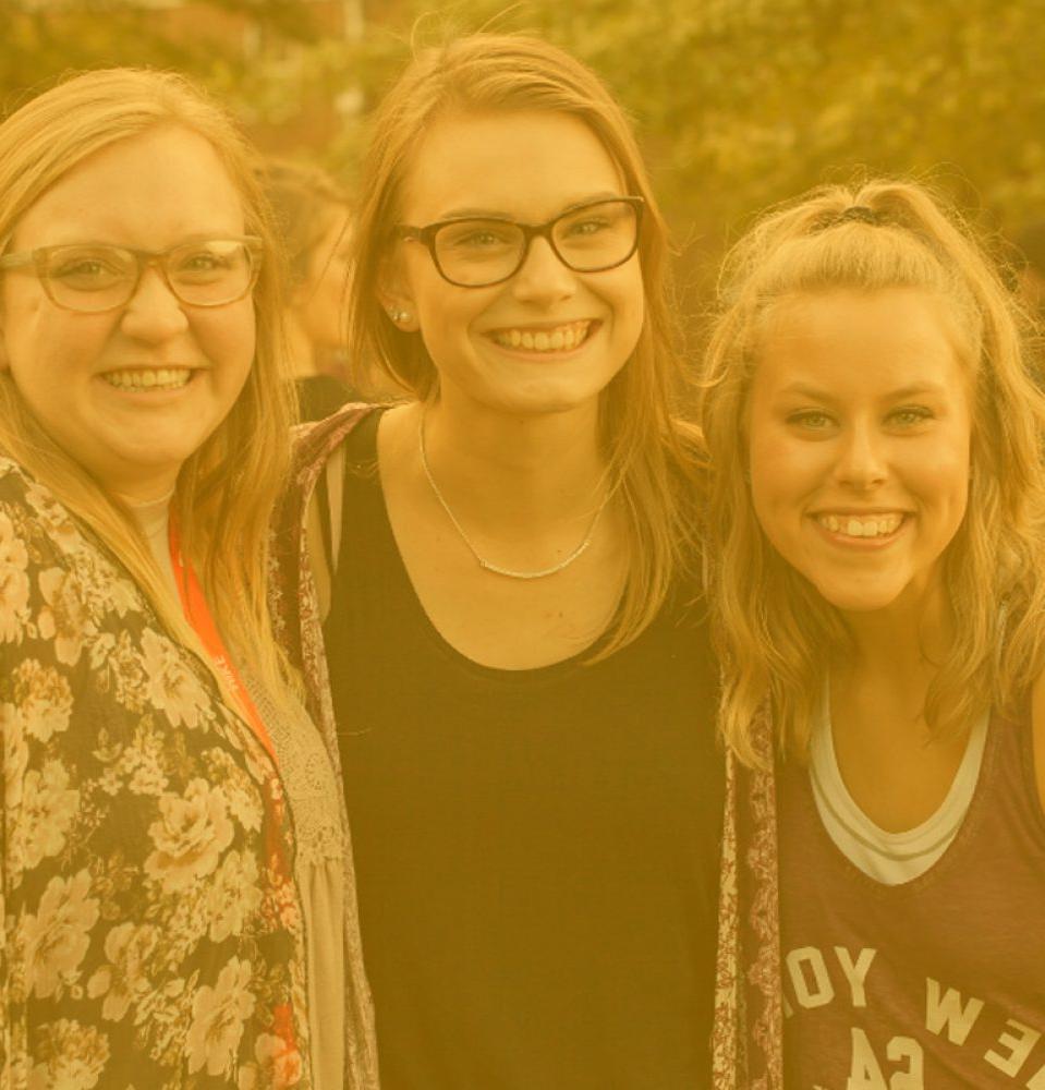 three college girls posing and smiling
